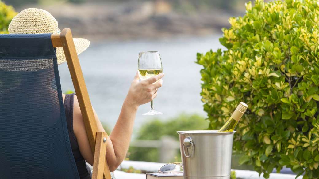 Royal Duchy Hotel Guest in Deck Chair with Wine Looking Out at Pendennis