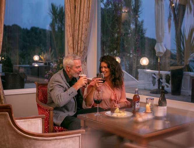 A couple having drinks and an evening bar meal