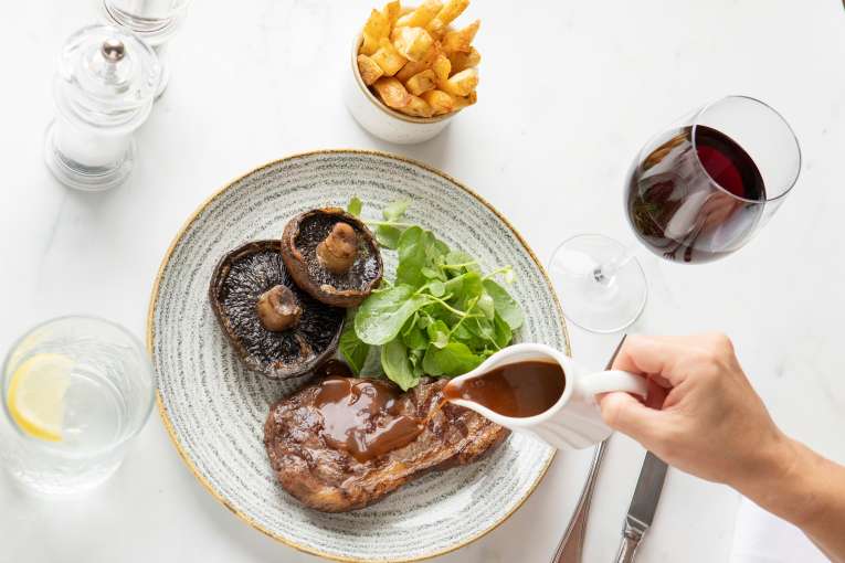 Steak meal with glass of red wine