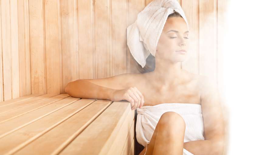 Woman in sauna steam on face spa
