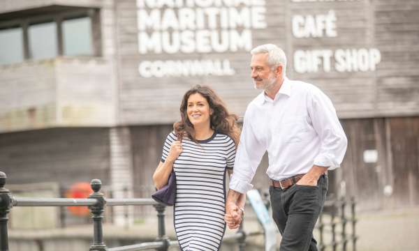 Couple walking outside the National Maritime Museum in Cornwall