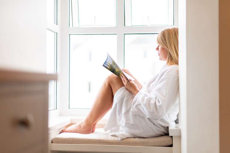 Lady reading on window ledge at the royal duchy hotel